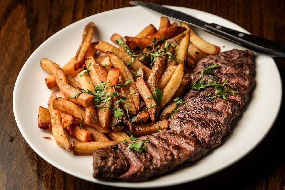Sliced beef steak with hand-cut fries